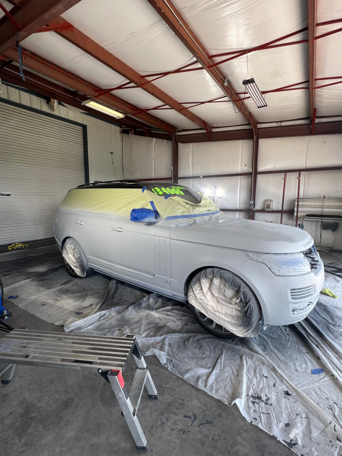 Land Rover in primer inside the paint booth