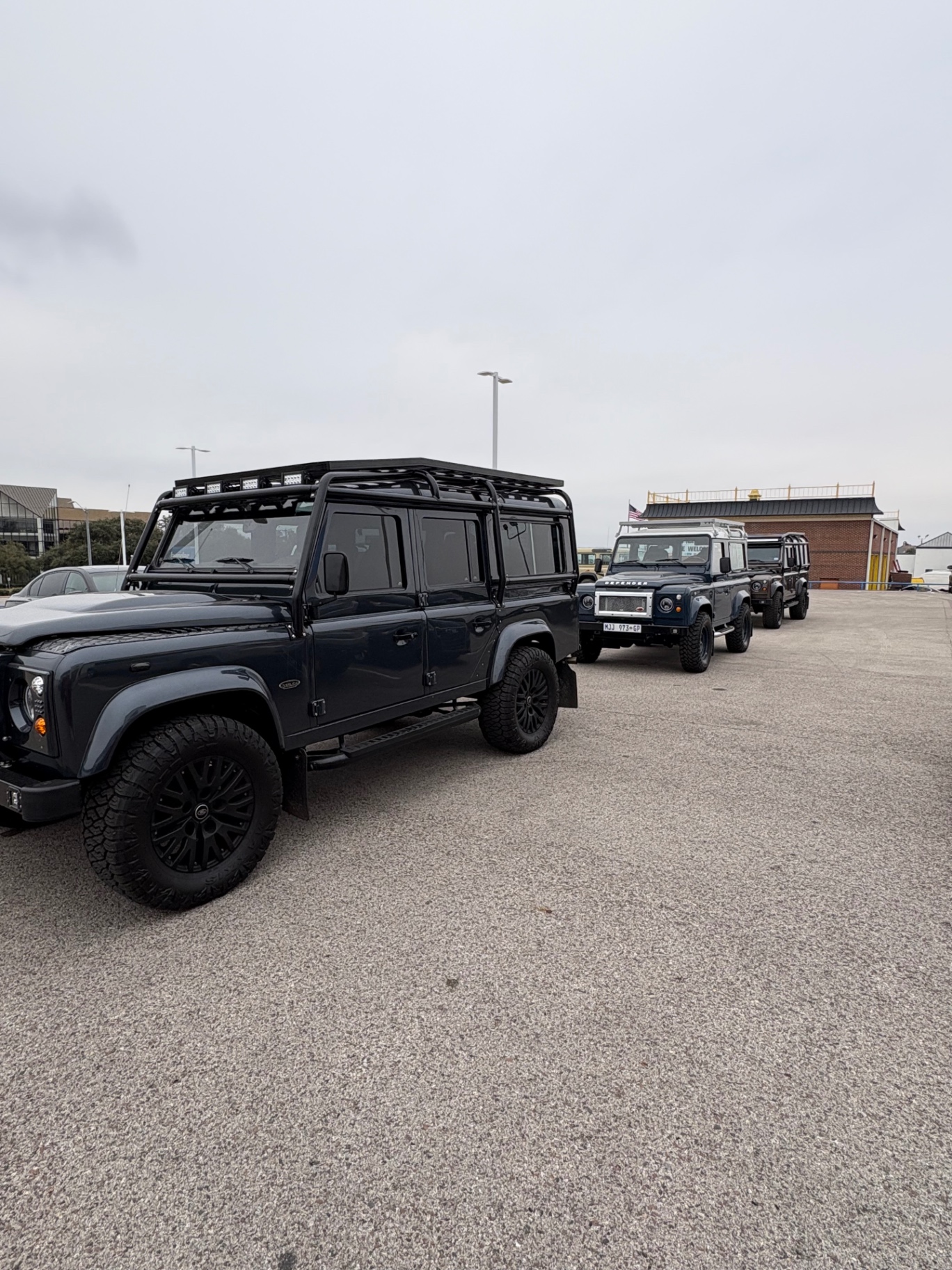 Row of custom Land Rover Defender 110 builds ready for delivery