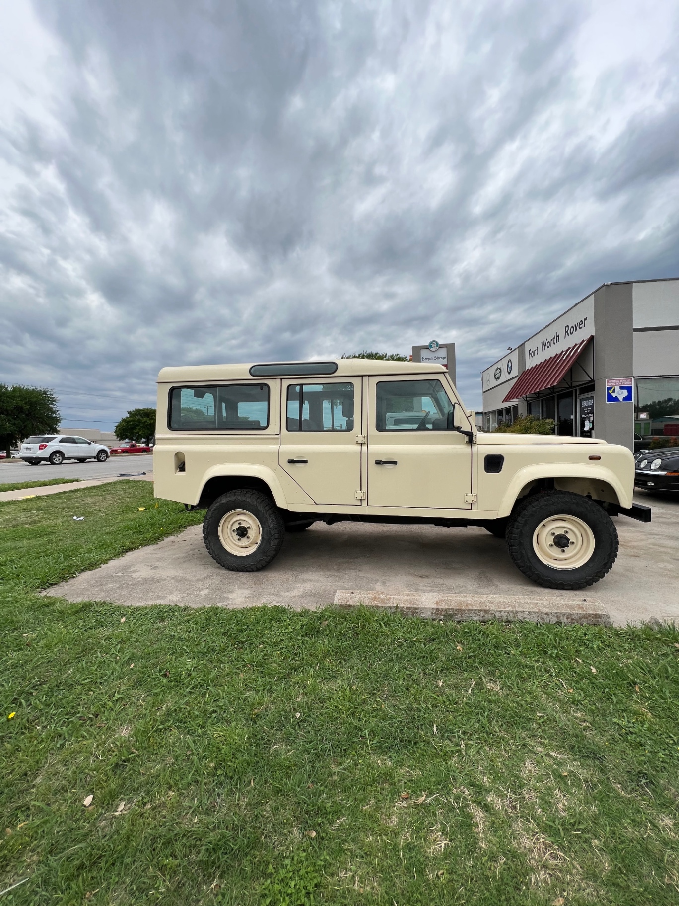 Cream Defender 110 parked outside the Fort Worth Rover storefront