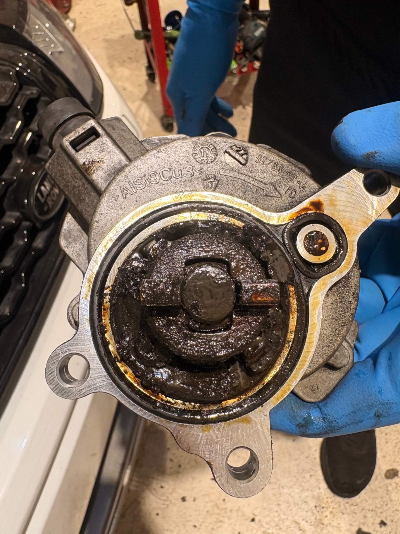 Vacuum pump opened up showing oil sludge from missed service intervals