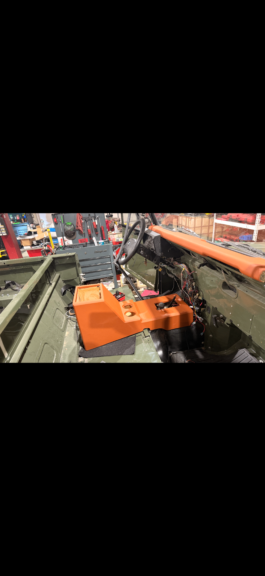 Orange console installed in an olive Defender