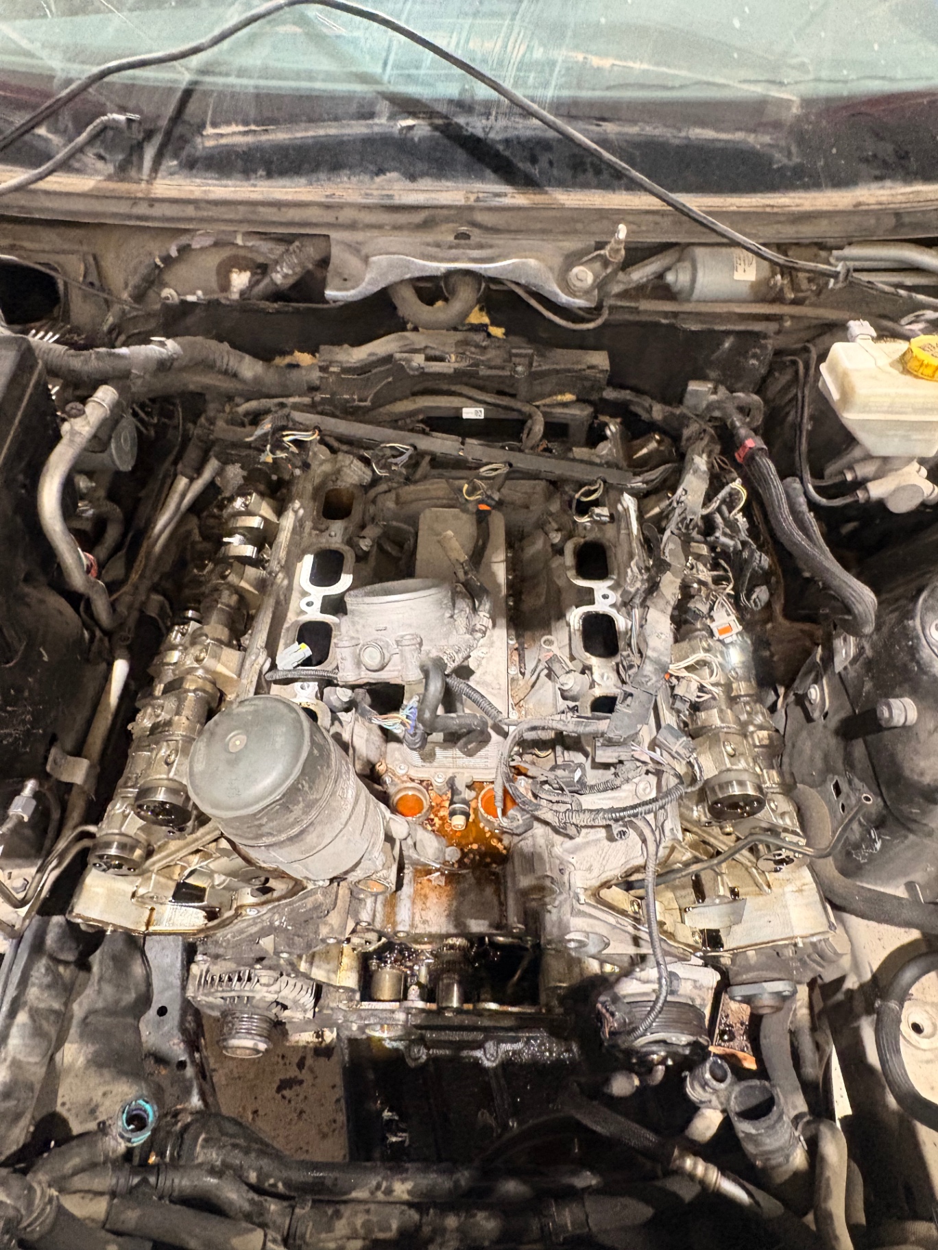 Land Rover V8 engine mid-teardown with intake removed and valley exposed