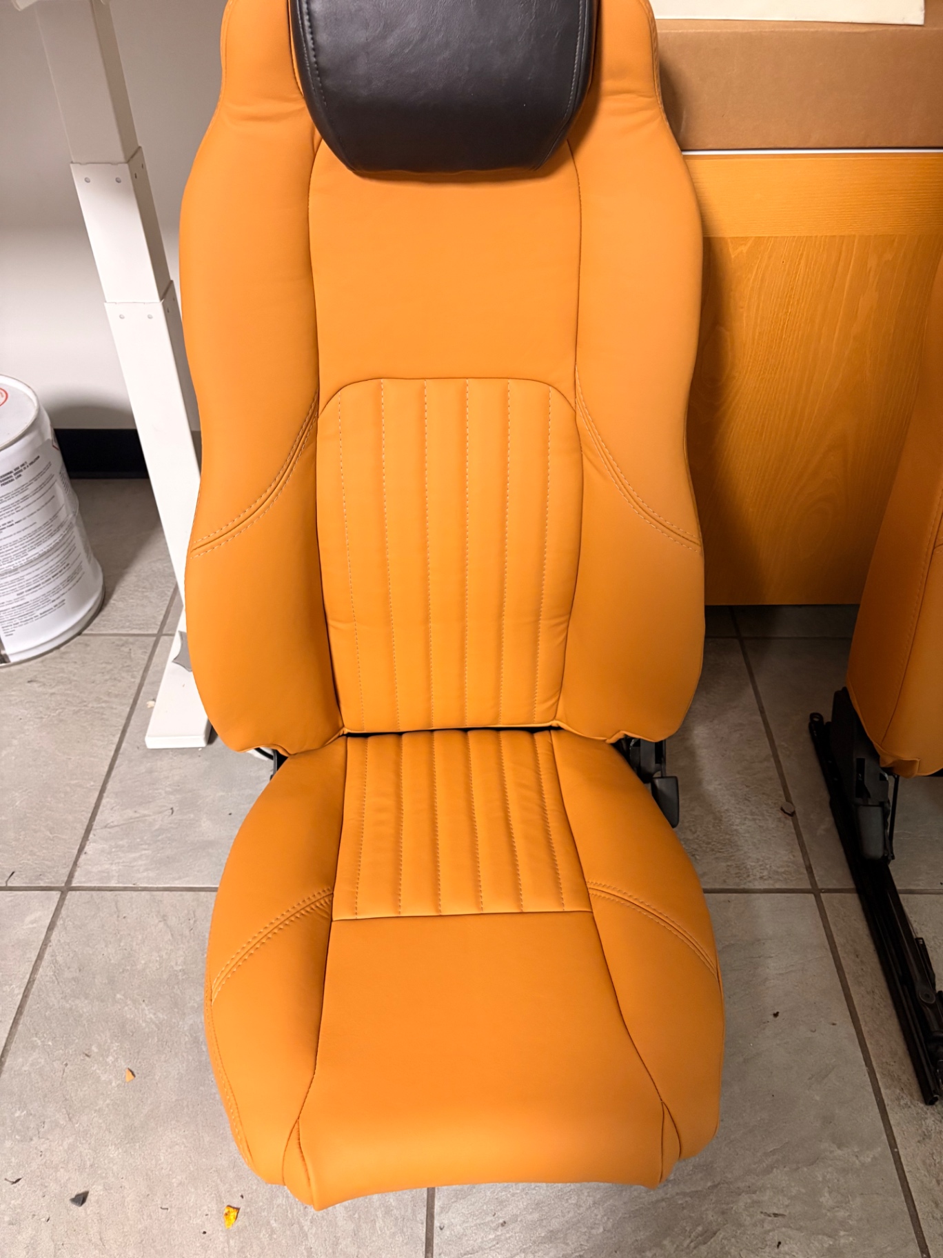Burnt-orange leather Defender seat with vertical stitched center panel