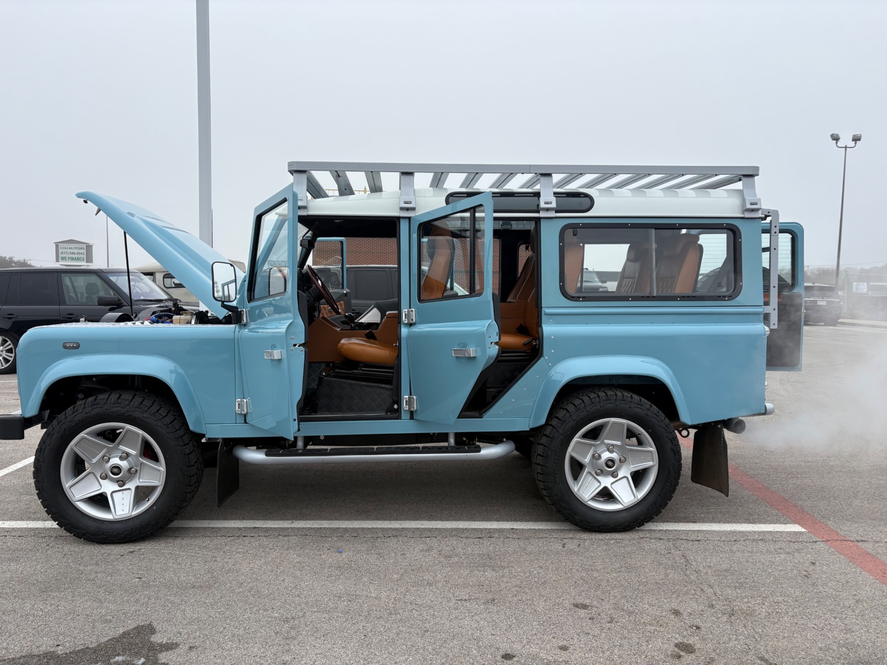 Sky blue Defender 110 with tan diamond-stitched interior at Fort Worth Rover